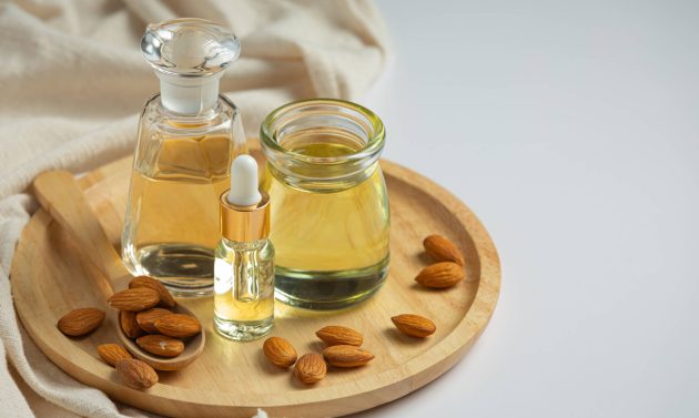 Almond oil in bottle on white background